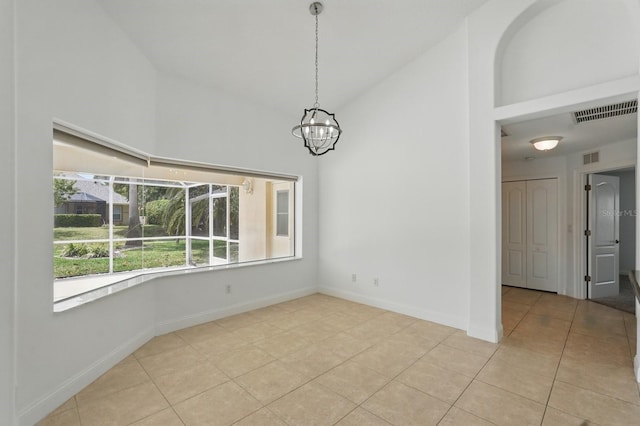 47 Old Oak Dr S, Palm Coast, FL 32137 - unfurnished dining area with high vaulted ceiling, light tile patterned flooring, a chandelier, and baseboards