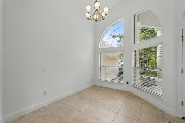 47 Old Oak Dr S, Palm Coast, FL 32137 - empty room with light tile patterned flooring, a chandelier, and baseboards
