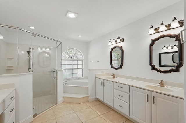 47 Old Oak Dr S, Palm Coast, FL 32137 - bathroom with a garden tub, a shower stall, double vanity, tile patterned floors, and recessed lighting