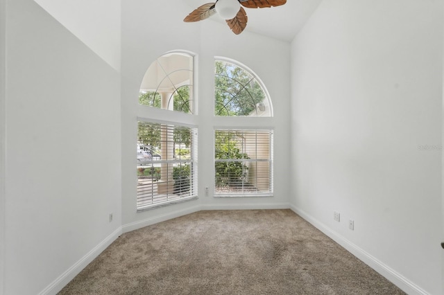 47 Old Oak Dr S, Palm Coast, FL 32137 - carpeted empty room with healthy amount of natural light, ceiling fan, baseboards, and high vaulted ceiling