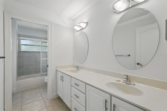 47 Old Oak Dr S, Palm Coast, FL 32137 - full bathroom with tile patterned flooring, double vanity, toilet, combined bath / shower with glass door, and a textured ceiling
