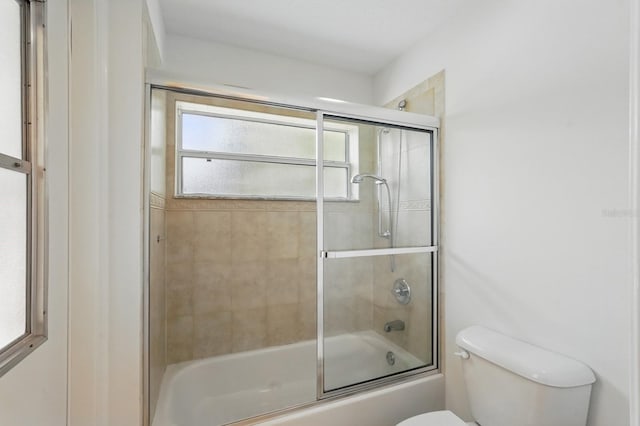 47 Old Oak Dr S, Palm Coast, FL 32137 - bathroom featuring toilet and shower / bath combination with glass door