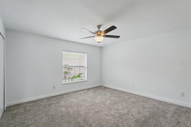 47 Old Oak Dr S, Palm Coast, FL 32137 - carpeted spare room with a ceiling fan, baseboards, and a textured ceiling
