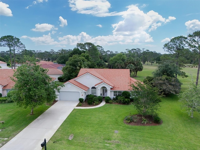 6 Sutton Ct, Palm Coast, FL 32164 - mediterranean / spanish home with a garage, a front lawn, a tiled roof, driveway, and stucco siding