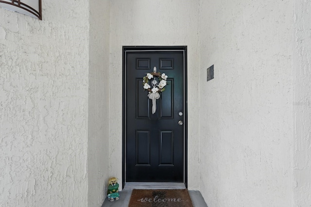 200 Bella Harbor Ct Unit 105, Palm Coast, FL 32137 - doorway to property featuring stucco siding