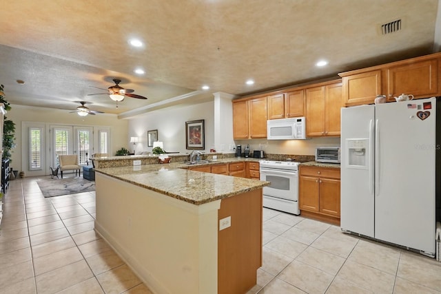 200 Bella Harbor Ct Unit 105, Palm Coast, FL 32137 - kitchen featuring white appliances, a peninsula, a sink, light tile patterned floors, and recessed lighting