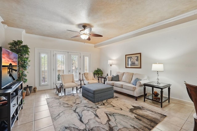 200 Bella Harbor Ct Unit 105, Palm Coast, FL 32137 - living room with a ceiling fan, light tile patterned floors, a textured ceiling, baseboards, and ornamental molding