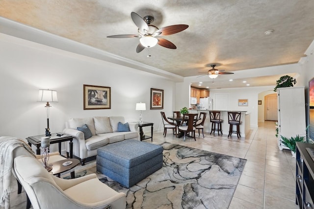200 Bella Harbor Ct Unit 105, Palm Coast, FL 32137 - living room featuring ceiling fan, arched walkways, recessed lighting, light tile patterned floors, and baseboards