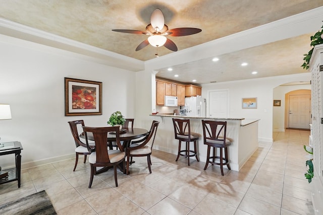200 Bella Harbor Ct Unit 105, Palm Coast, FL 32137 - dining room with arched walkways, recessed lighting, light tile patterned floors, a ceiling fan, and baseboards