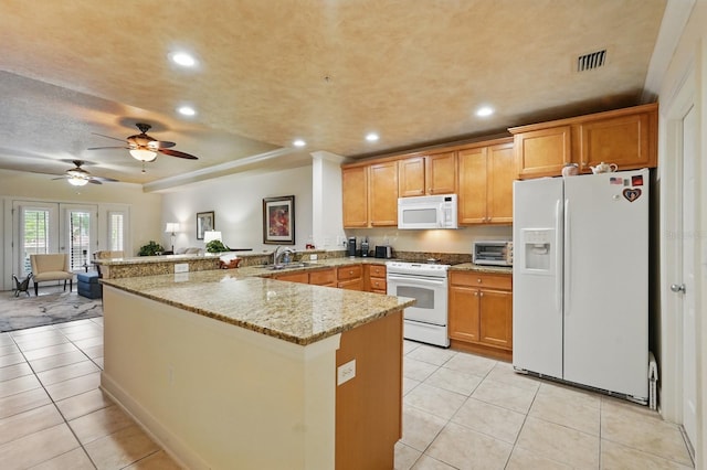 200 Bella Harbor Ct Unit 105, Palm Coast, FL 32137 - kitchen featuring white appliances, a peninsula, a sink, light tile patterned floors, and recessed lighting
