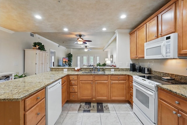 200 Bella Harbor Ct Unit 105, Palm Coast, FL 32137 - kitchen with white appliances, a sink, ornamental molding, light tile patterned flooring, and a peninsula