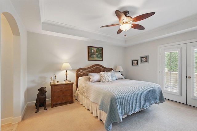 200 Bella Harbor Ct Unit 105, Palm Coast, FL 32137 - bedroom with a tray ceiling, access to outside, light carpet, ornamental molding, and french doors
