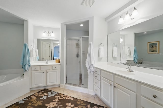 200 Bella Harbor Ct Unit 105, Palm Coast, FL 32137 - bathroom with a shower stall, tile patterned flooring, a garden tub, two vanities, and recessed lighting