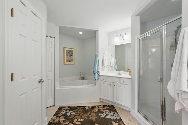 200 Bella Harbor Ct Unit 105, Palm Coast, FL 32137 - full bathroom with tile patterned floors, a stall shower, a garden tub, vanity, and recessed lighting