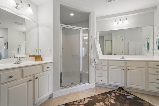 200 Bella Harbor Ct Unit 105, Palm Coast, FL 32137 - full bathroom with a shower stall, tile patterned flooring, and two vanities