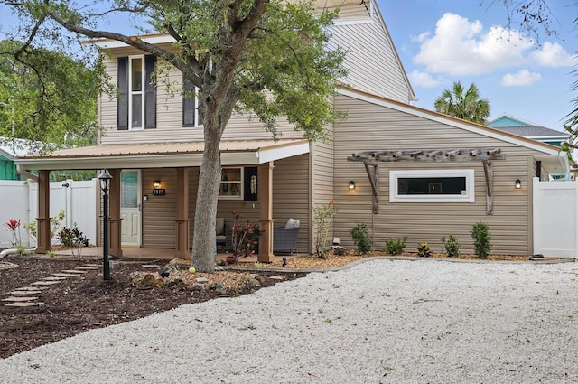 1819 S Flagler Ave, Flagler Beach, FL 32136 - view of front facade featuring covered porch and fence