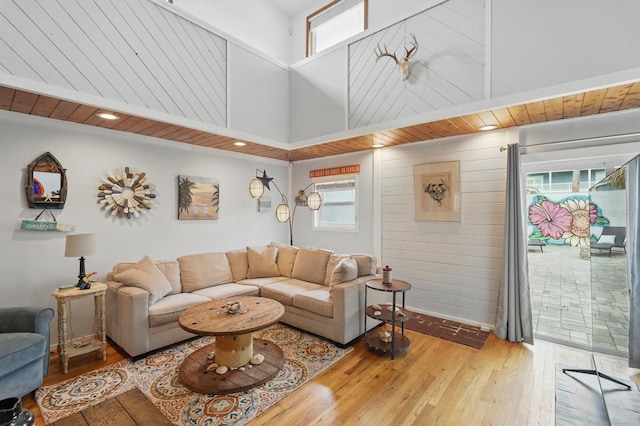 1819 S Flagler Ave, Flagler Beach, FL 32136 - living room featuring plenty of natural light, hardwood / wood-style flooring, a high ceiling, and wooden walls