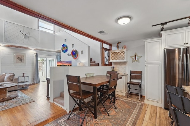 1819 S Flagler Ave, Flagler Beach, FL 32136 - dining room featuring stairs, plenty of natural light, and light wood-style flooring