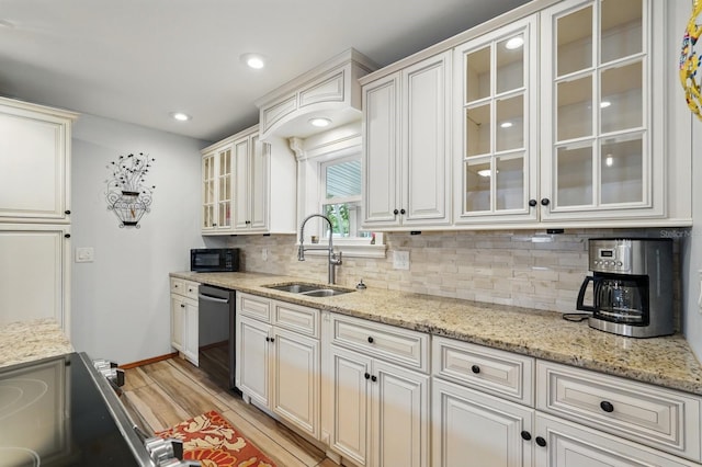 1819 S Flagler Ave, Flagler Beach, FL 32136 - kitchen with a sink, dishwasher, light wood-type flooring, backsplash, and range with electric stovetop