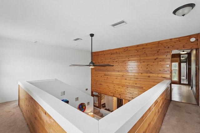 1819 S Flagler Ave, Flagler Beach, FL 32136 - hallway featuring light colored carpet, an upstairs landing, and wooden walls