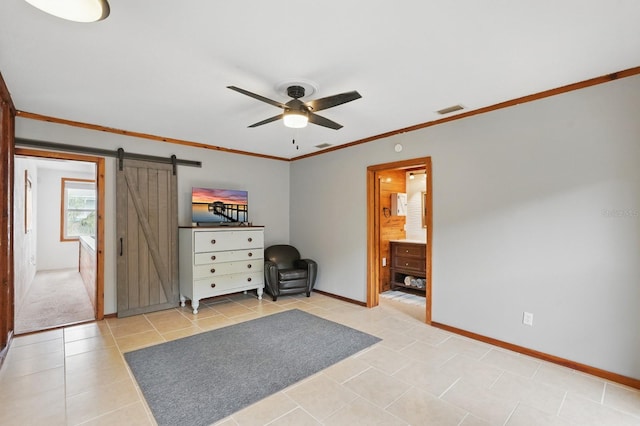 1819 S Flagler Ave, Flagler Beach, FL 32136 - bedroom featuring a barn door, baseboards, light tile patterned floors, crown molding, and ensuite bathroom