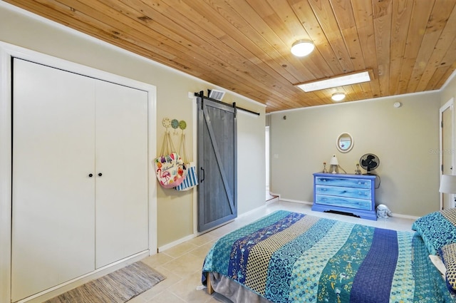 1819 S Flagler Ave, Flagler Beach, FL 32136 - bedroom featuring wood ceiling, a barn door, tile patterned floors, baseboards, and a skylight
