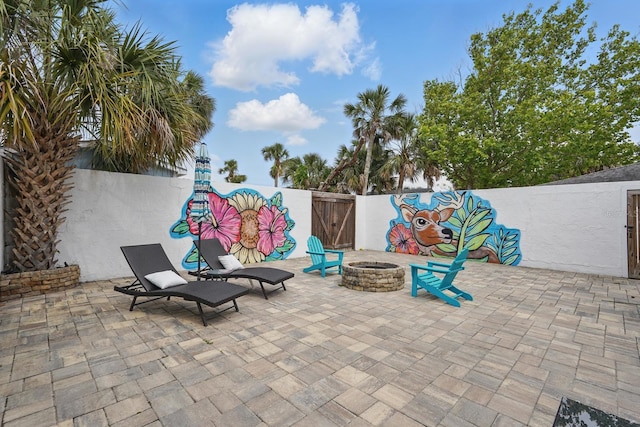 1819 S Flagler Ave, Flagler Beach, FL 32136 - view of patio featuring an outdoor fire pit and a fenced backyard