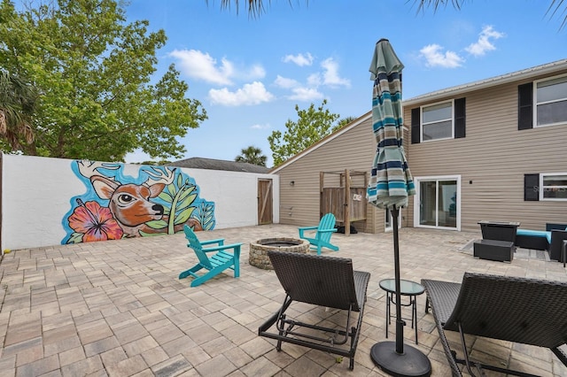 1819 S Flagler Ave, Flagler Beach, FL 32136 - view of patio featuring an outdoor living space with a fire pit and fence