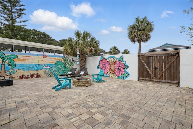 1819 S Flagler Ave, Flagler Beach, FL 32136 - view of patio featuring a gate, a fire pit, and fence