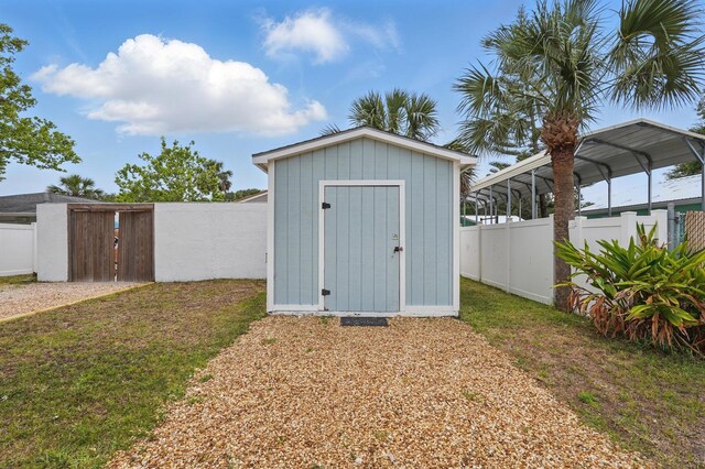 1819 S Flagler Ave, Flagler Beach, FL 32136 - view of shed featuring a gate and a carport