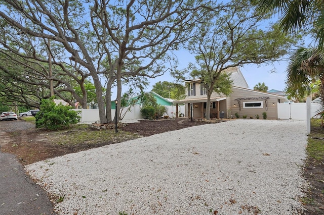 1819 S Flagler Ave, Flagler Beach, FL 32136 - view of front facade featuring driveway, fence, and a gate