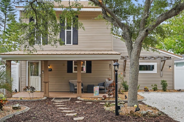 1819 S Flagler Ave, Flagler Beach, FL 32136 - view of front of house featuring metal roof and covered porch