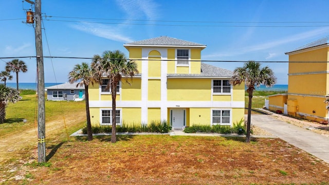 7029 N Ocean Shore Blvd, Palm Coast, FL 32137 - view of front of home featuring stucco siding and roof with shingles