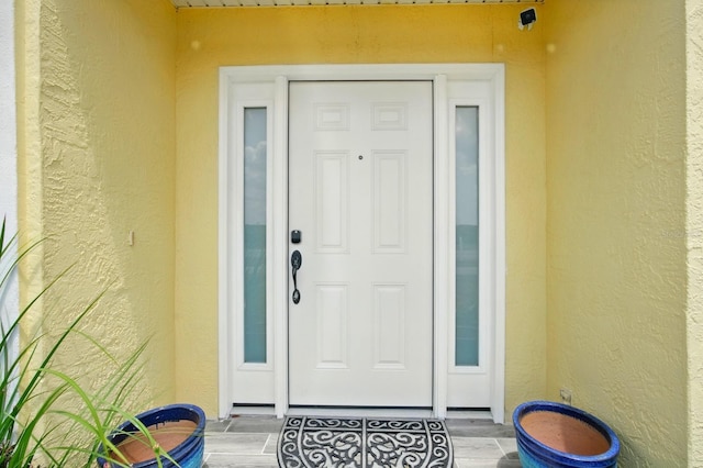 7029 N Ocean Shore Blvd, Palm Coast, FL 32137 - doorway to property featuring stucco siding