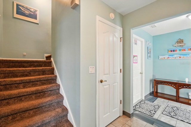 7029 N Ocean Shore Blvd, Palm Coast, FL 32137 - stairway featuring tile patterned flooring and baseboards