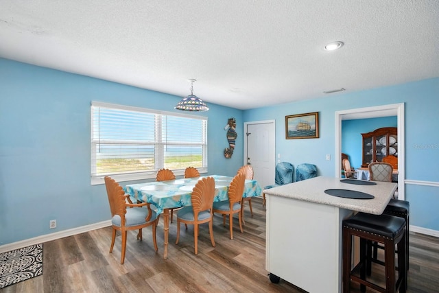 7029 N Ocean Shore Blvd, Palm Coast, FL 32137 - dining space with a textured ceiling, dark wood-style flooring, baseboards, and recessed lighting