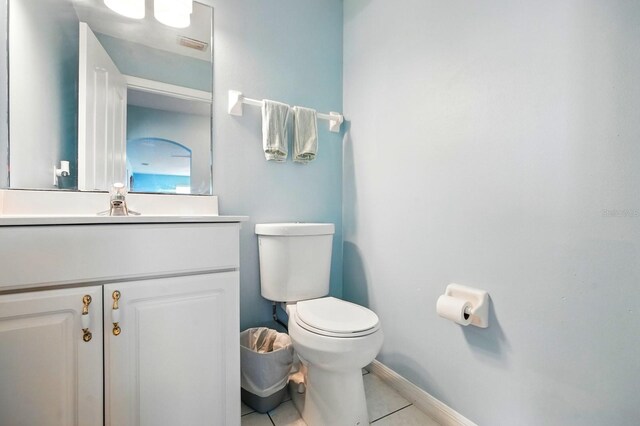 7029 N Ocean Shore Blvd, Palm Coast, FL 32137 - bathroom featuring tile patterned floors, toilet, baseboards, and vanity