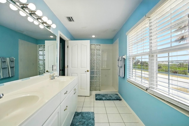 7029 N Ocean Shore Blvd, Palm Coast, FL 32137 - bathroom with tile patterned floors, a tile shower, double vanity, baseboards, and recessed lighting