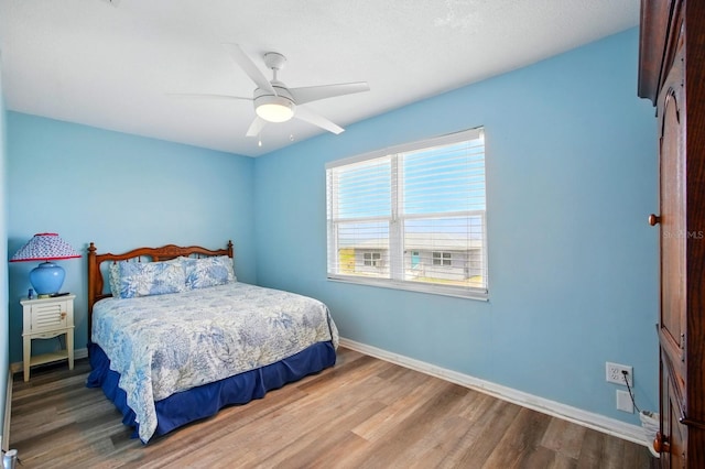 7029 N Ocean Shore Blvd, Palm Coast, FL 32137 - bedroom with wood finished floors, baseboards, and a ceiling fan
