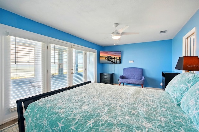 7029 N Ocean Shore Blvd, Palm Coast, FL 32137 - bedroom with access to exterior, baseboards, and a ceiling fan