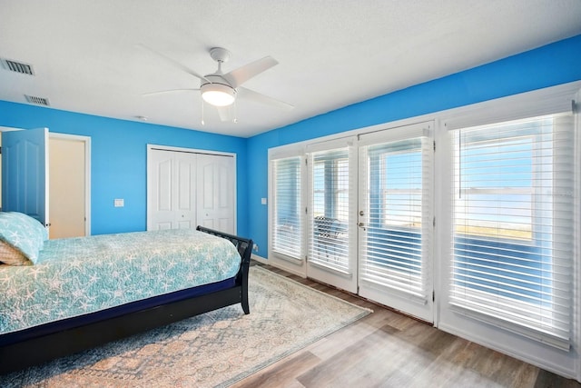 7029 N Ocean Shore Blvd, Palm Coast, FL 32137 - bedroom featuring access to outside, wood finished floors, a closet, ceiling fan, and baseboards