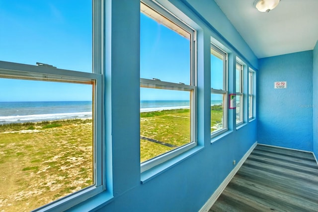7029 N Ocean Shore Blvd, Palm Coast, FL 32137 - doorway to outside with a water view, baseboards, wood finished floors, and healthy amount of natural light