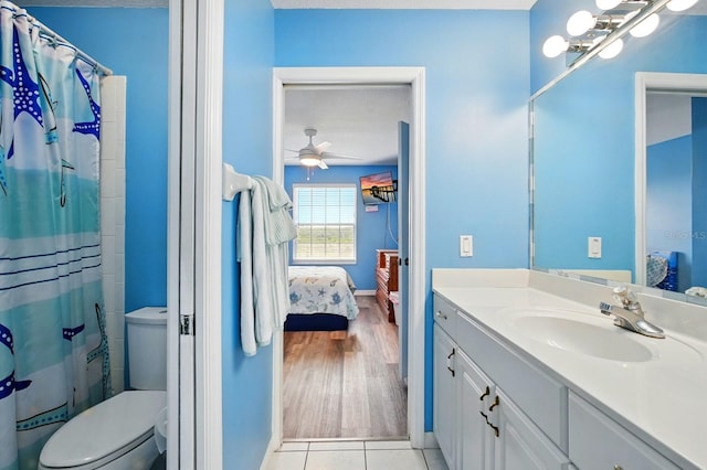 7029 N Ocean Shore Blvd, Palm Coast, FL 32137 - bathroom featuring connected bathroom, vanity, ceiling fan, and toilet