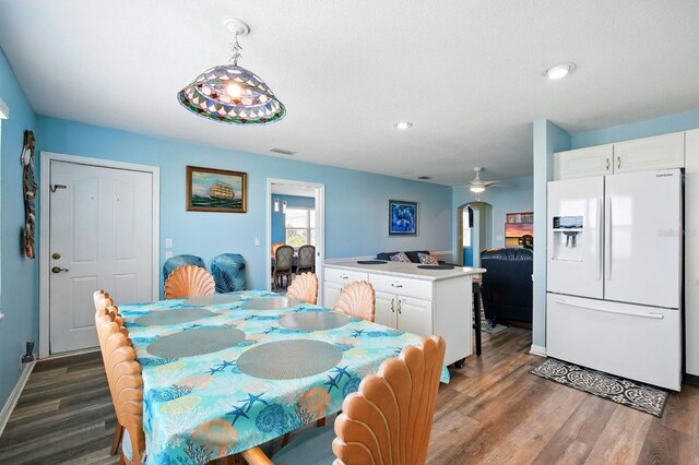 7029 N Ocean Shore Blvd, Palm Coast, FL 32137 - dining area with wood finished floors, recessed lighting, ceiling fan, arched walkways, and baseboards