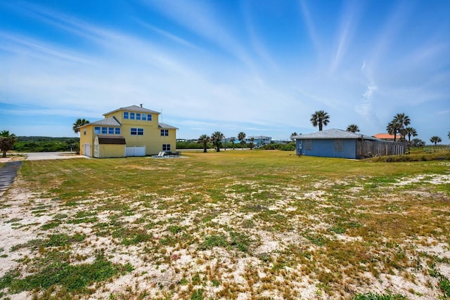 7029 N Ocean Shore Blvd, Palm Coast, FL 32137 - view of grassy yard with an attached garage