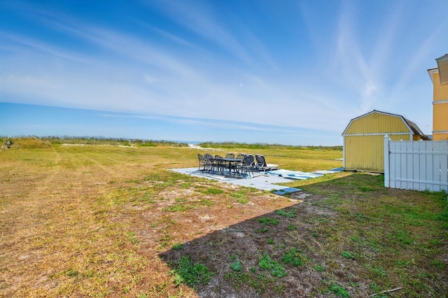 7029 N Ocean Shore Blvd, Palm Coast, FL 32137 - view of green lawn with an outbuilding and a patio area
