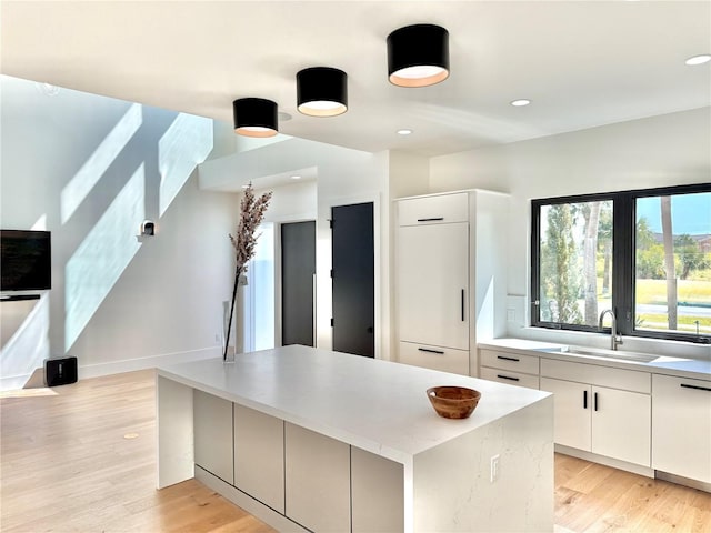 807 N Flagler Ave, Flagler Beach, FL 32136 - kitchen with a sink, dishwasher, light wood-style flooring, a center island, and recessed lighting
