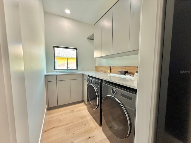 807 N Flagler Ave, Flagler Beach, FL 32136 - washroom with washer and clothes dryer, light wood-style floors, cabinet space, and recessed lighting