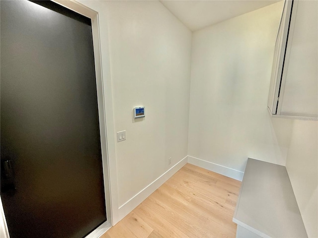 807 N Flagler Ave, Flagler Beach, FL 32136 - clothes washing area featuring light wood-style floors and baseboards