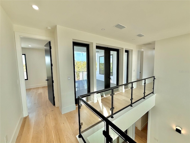 807 N Flagler Ave, Flagler Beach, FL 32136 - hallway featuring light wood finished floors, baseboards, and an upstairs landing